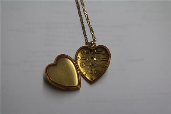 A Victorian yellow metal and gem set heart shaped pendant locket, on a later 9ct gold chain, locket 31mm.